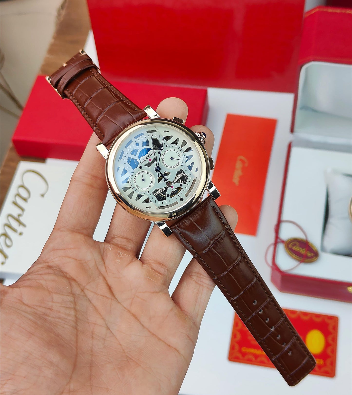 CA_TIER AUTOMATIC WATCH WITH A SKELETONIZED DIAL A BROWN LEATHER STRAP DAY AND DATE INDICATORS